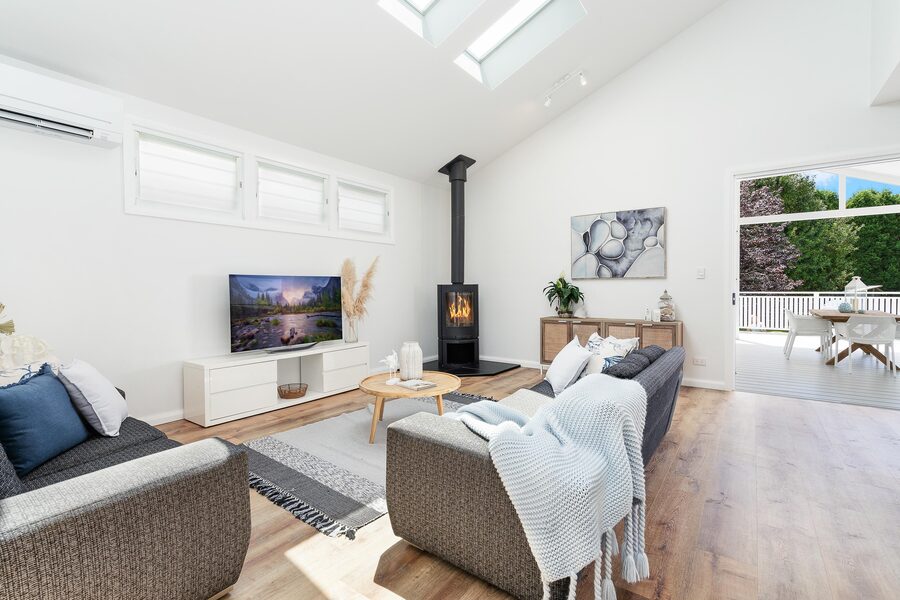 Living room with fireplace, timber floors and styled furnishings