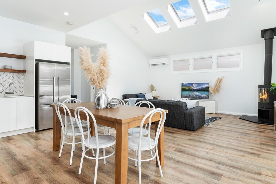 Open-plan kitchen and dining with skylights